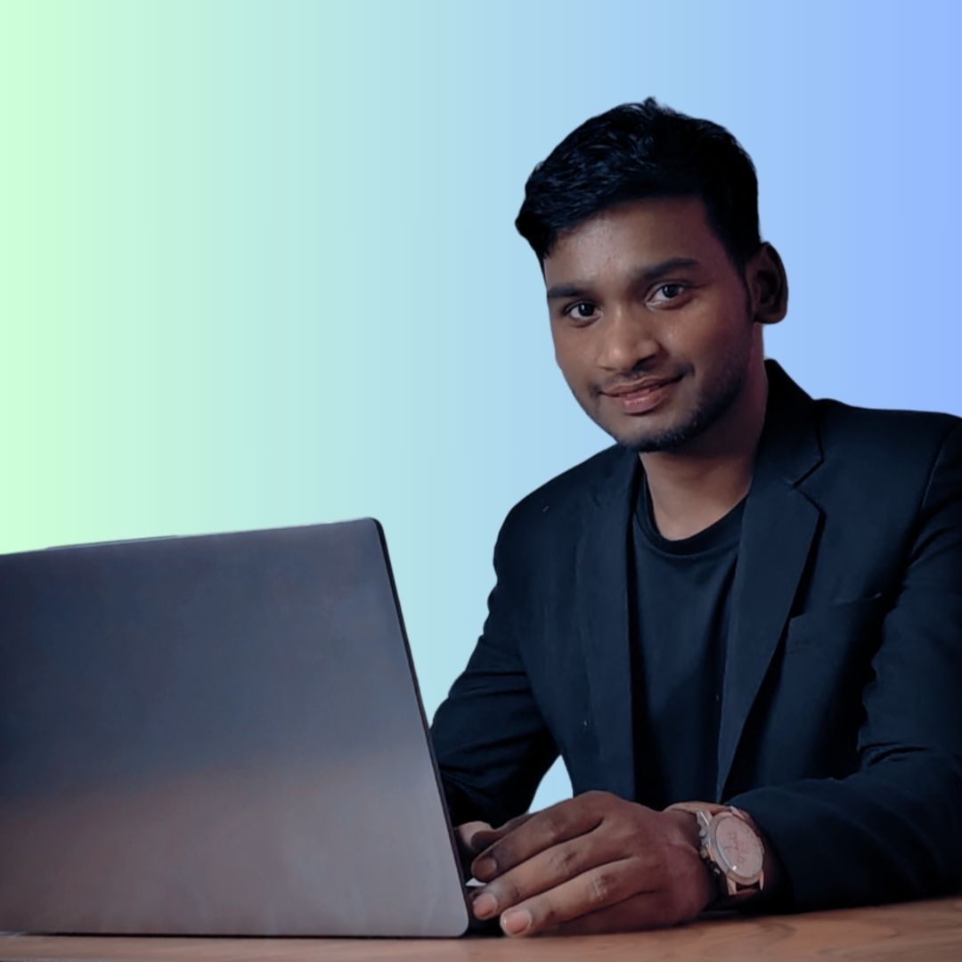 a man sitting at a desk with a laptop